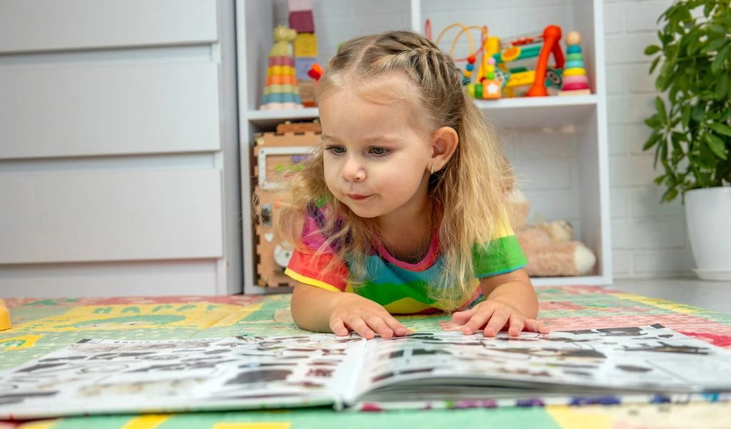 Young child reading a colorful picture book